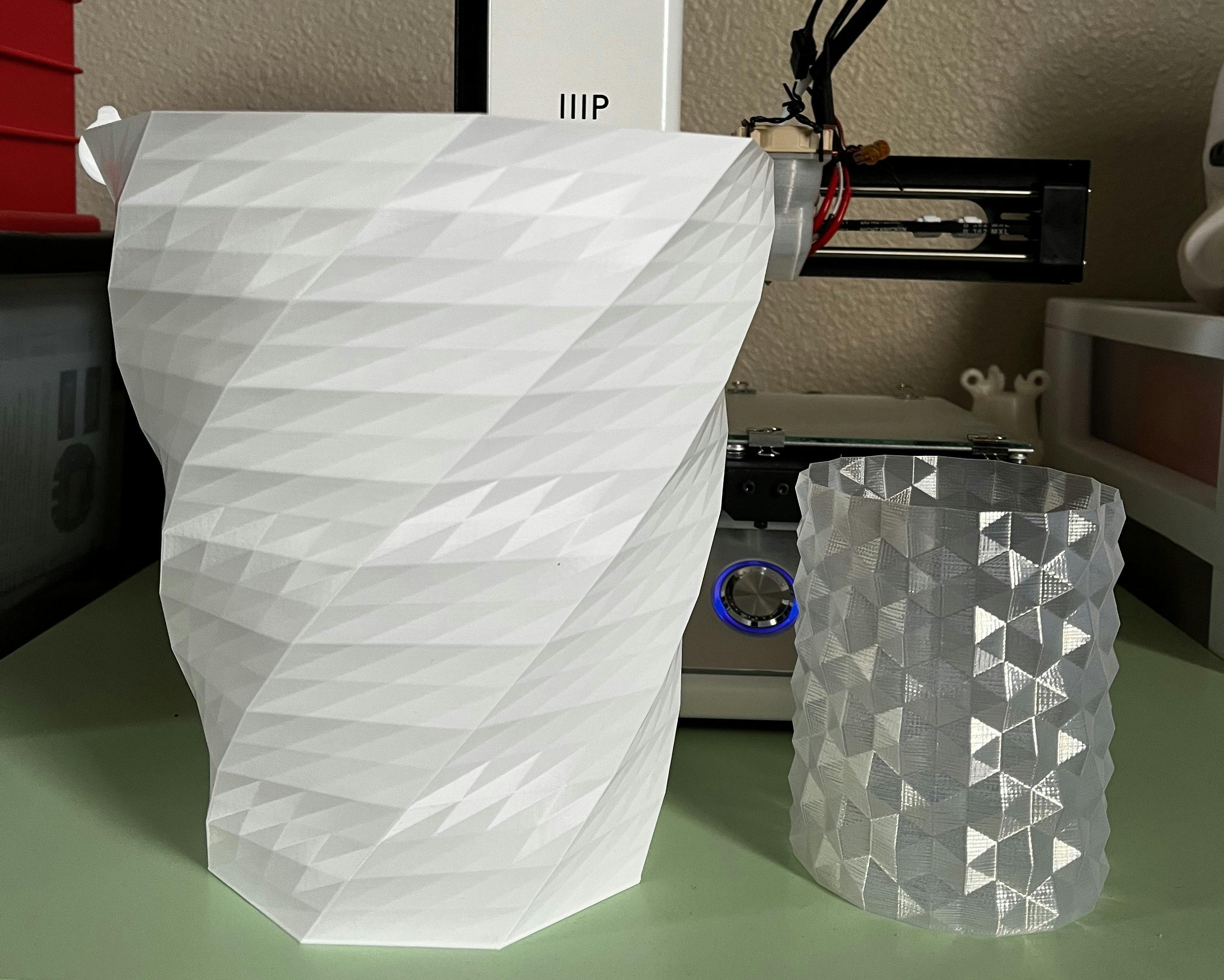 Two 3D printed vases, one larger than the other